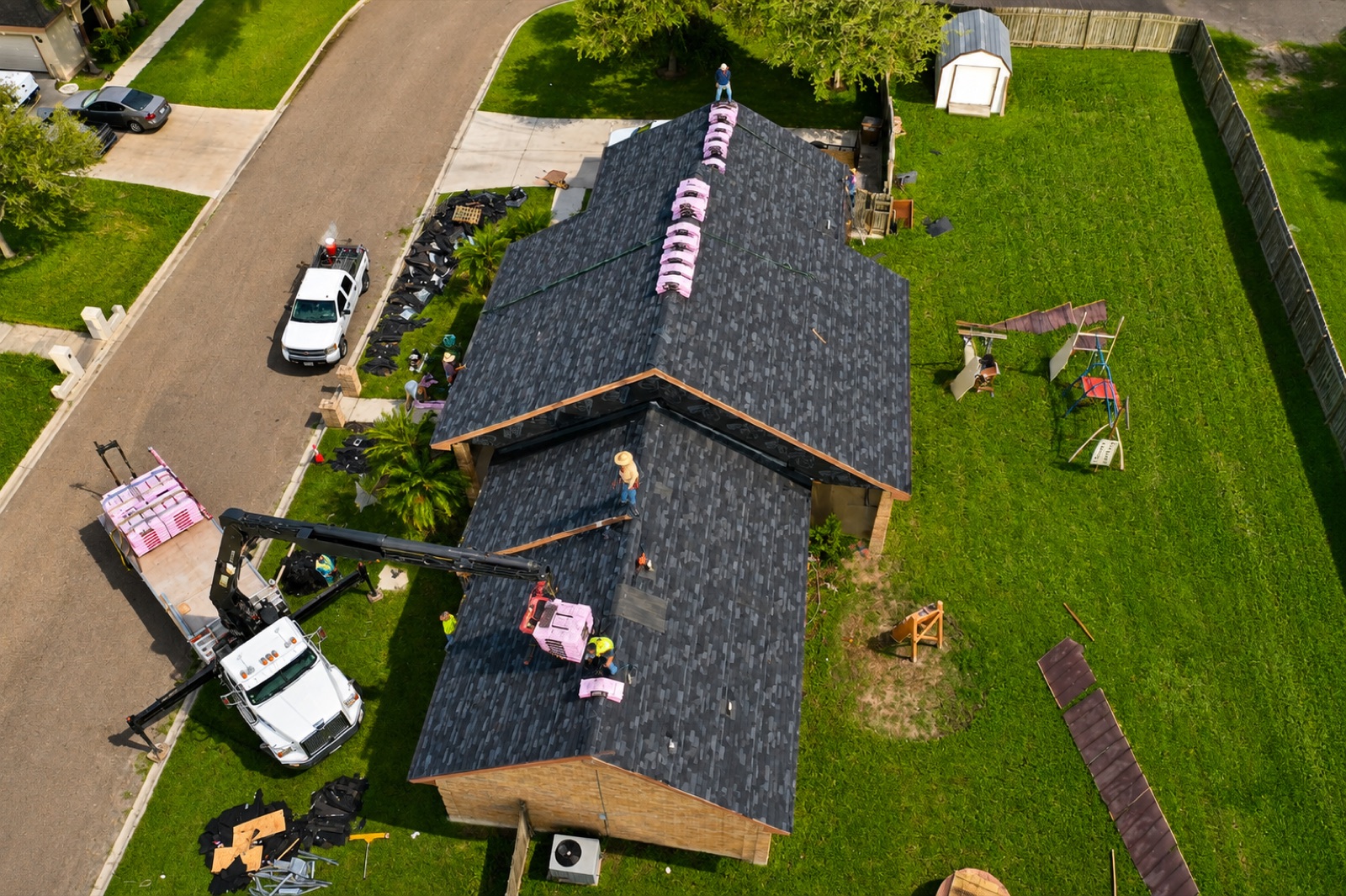 Texas Contractors crew loading shingles onto a new roof in the Rio Grande Valley