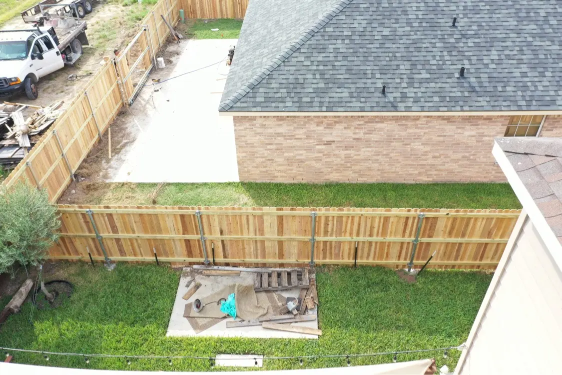 New cedar fence and new roof built by Texas Contractors, Inc. in Mission